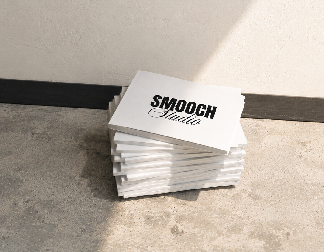 Stack of Smooch Studio business cards against a cream wall